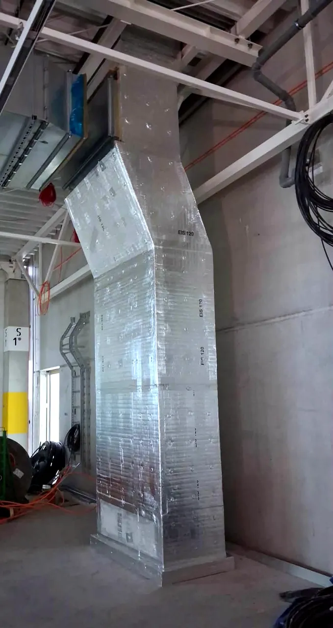 CONLIT fire-insulated riser ductwork rising through a steel structure