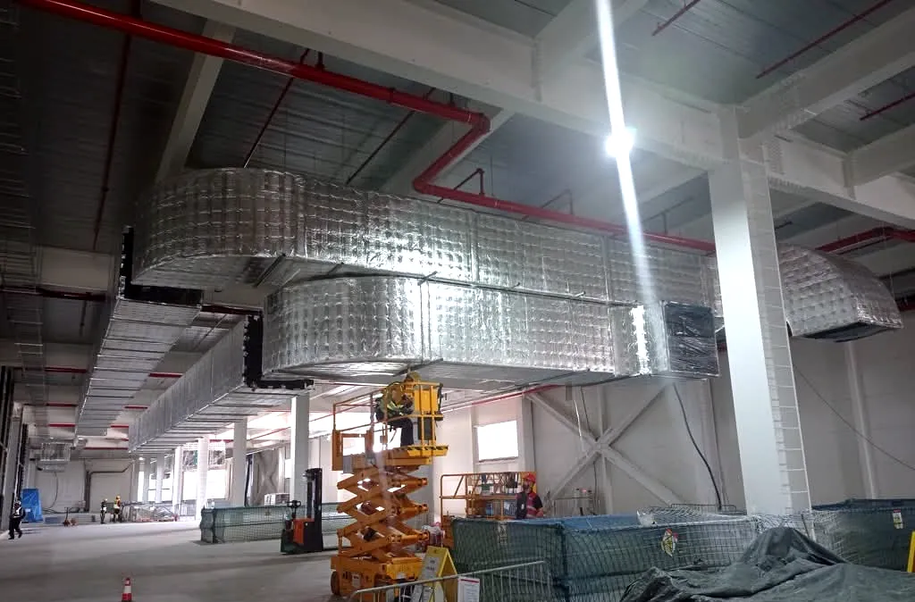Industrial ductwork installation inside a large production facility