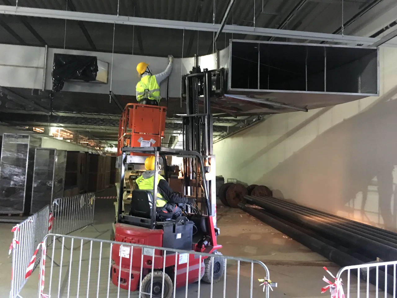 VSG installation team mounting large ventilation ductwork on an active construction site