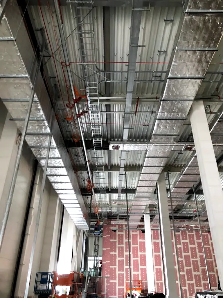 Thermally insulated ventilation ductwork and sprinkler piping at high level