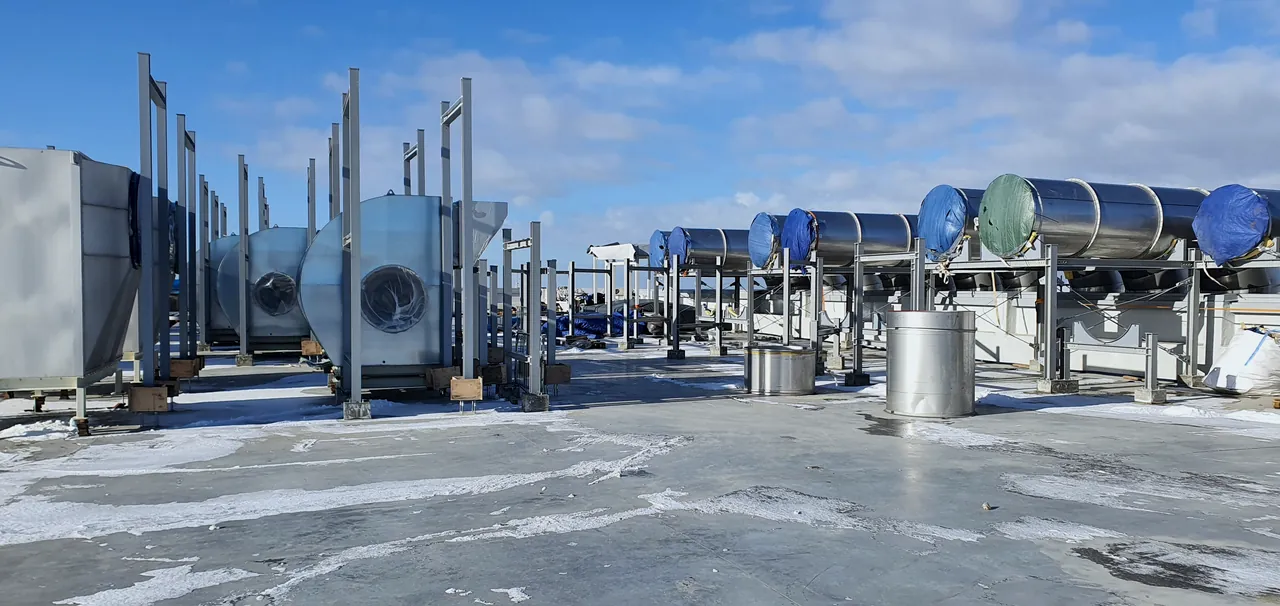 Rooftop HVAC fans and ventilation equipment on an industrial building